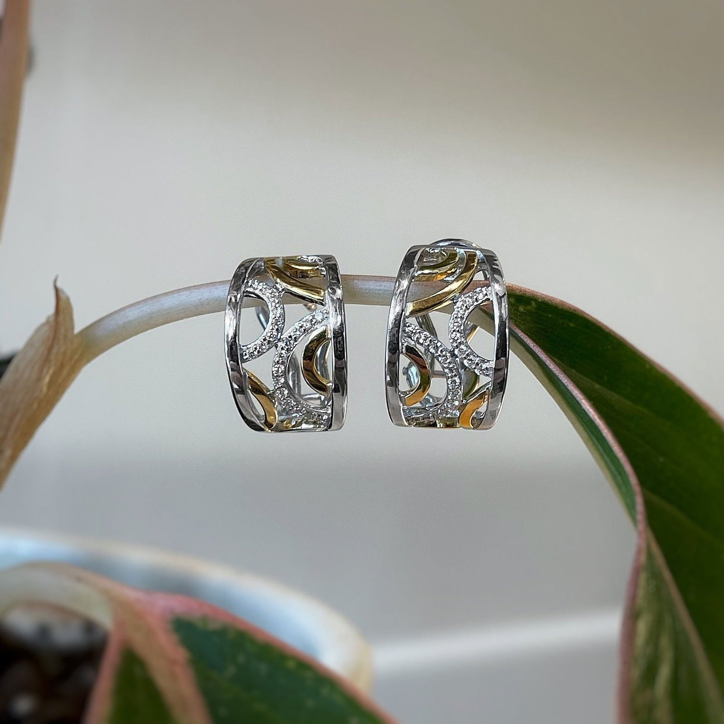 Photo of Breuning Diamond Circles Earrings in a decorative scene, designed by , available at Plumb Gold & Plumb Silver