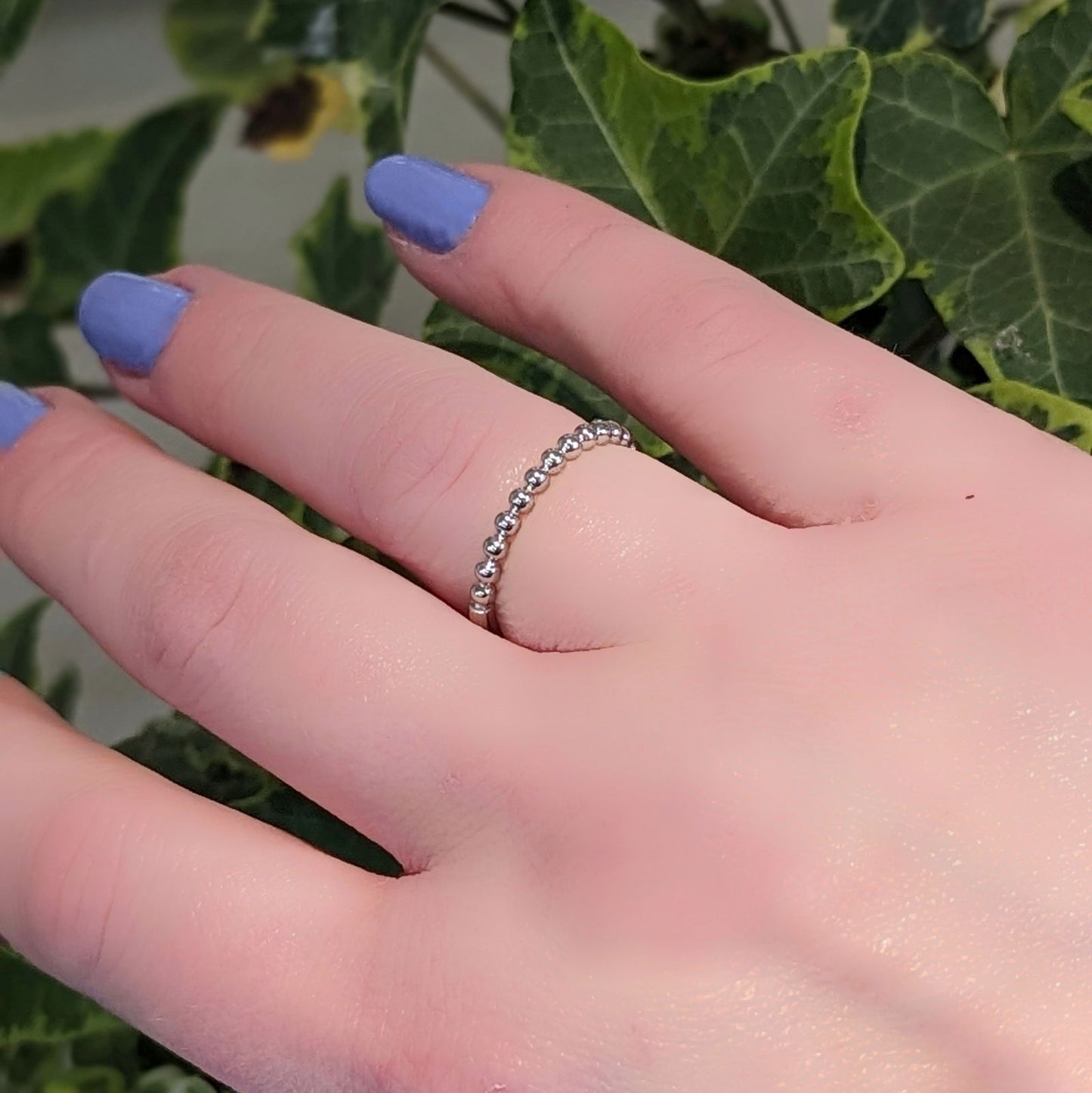 Photo of Bubbles Ring in a decorative scene, designed by , available at Plumb Gold & Plumb Silver