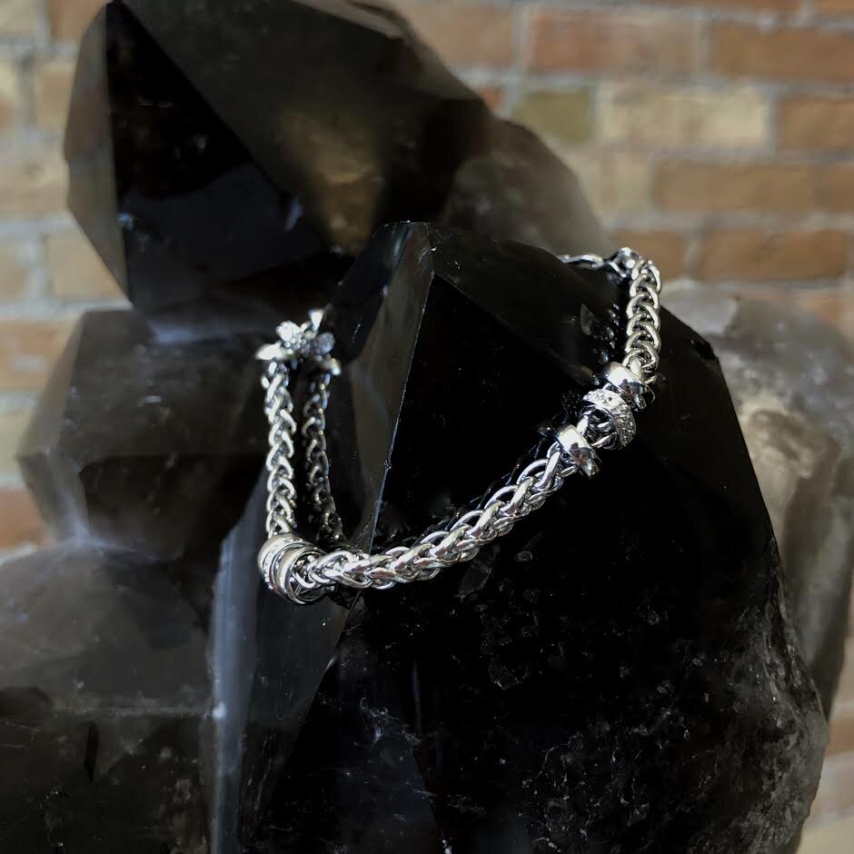 Photo of Cable Link Bracelet with Diamond Accents in a decorative scene, designed by , available at Plumb Gold & Plumb Silver