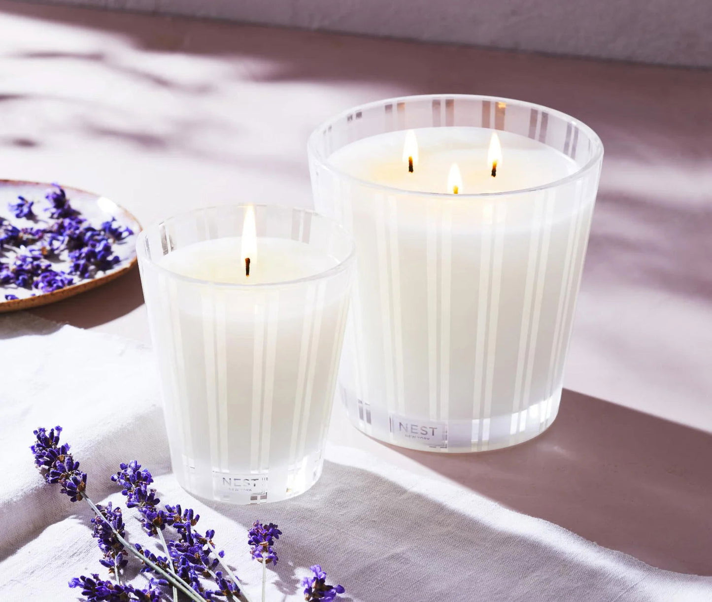 Photo of Cedar Leaf & Lavender Candle in a decorative scene, designed by , available at Plumb Gold & Plumb Silver