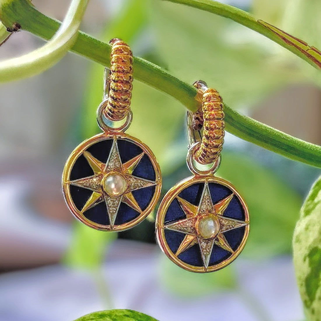 Photo of Celestial Blue Hoop Charms in a decorative scene, designed by , available at Plumb Gold & Plumb Silver