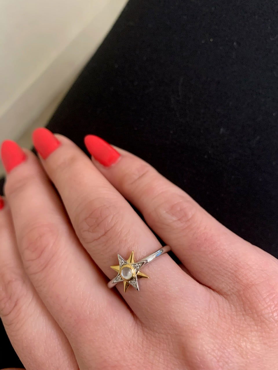 Photo of Celestial Star Ring in a decorative scene, designed by , available at Plumb Gold & Plumb Silver