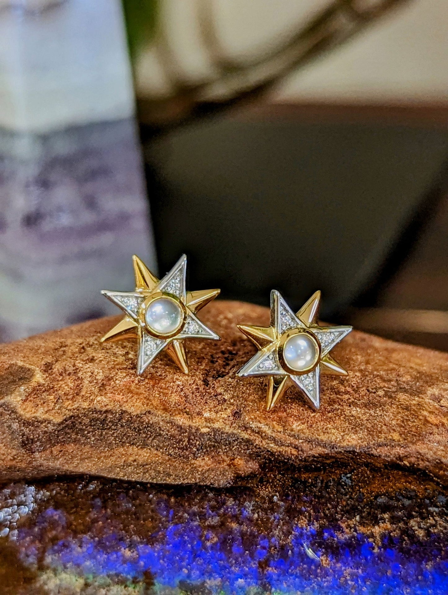 Photo of Celestial Stud Earring in a decorative scene, designed by , available at Plumb Gold & Plumb Silver