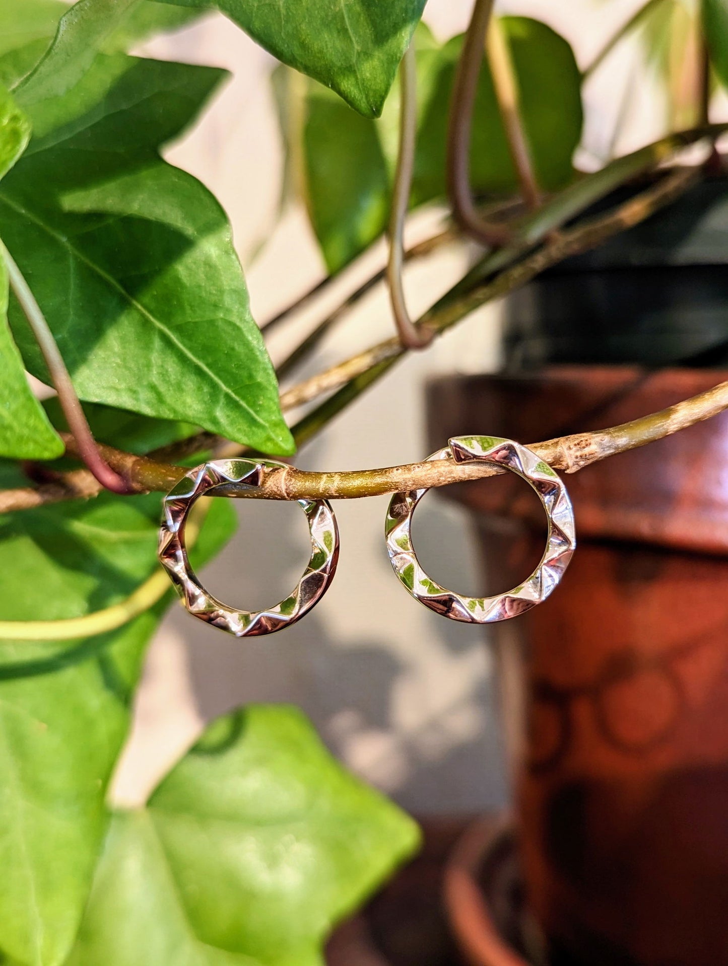 Photo of Chevron circle earrings in a decorative scene, designed by , available at Plumb Gold & Plumb Silver
