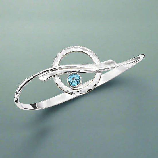 Photo of "Cloudburst" Bracelet in a decorative scene, designed by , available at Plumb Gold & Plumb Silver