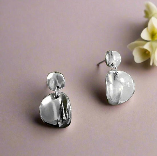 Photo of Convex Disc Earring in a decorative scene, designed by , available at Plumb Gold & Plumb Silver