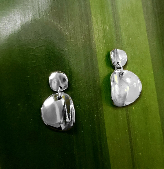 Photo of Convex Disc Earring in a decorative scene, designed by , available at Plumb Gold & Plumb Silver