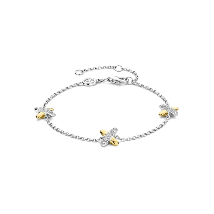 Photo of Cross Charm Bracelet in a decorative scene, designed by -, available at Plumb Gold & Plumb Silver