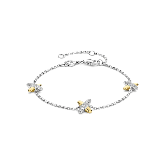 Photo of Cross Charm Bracelet in a decorative scene, designed by -, available at Plumb Gold & Plumb Silver