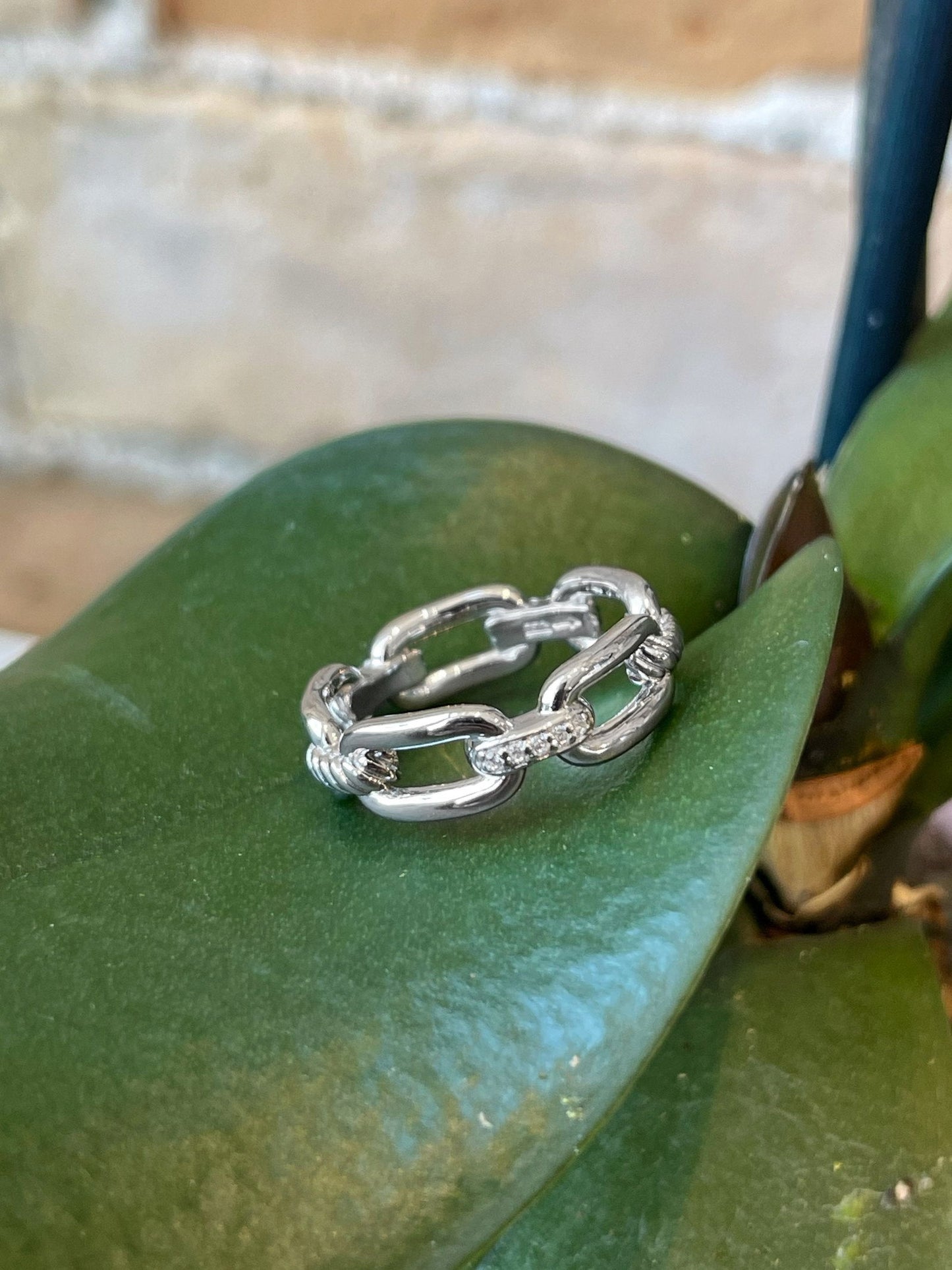 Photo of Cubic Zirconia Chain Link Ring in a decorative scene, designed by , available at Plumb Gold & Plumb Silver