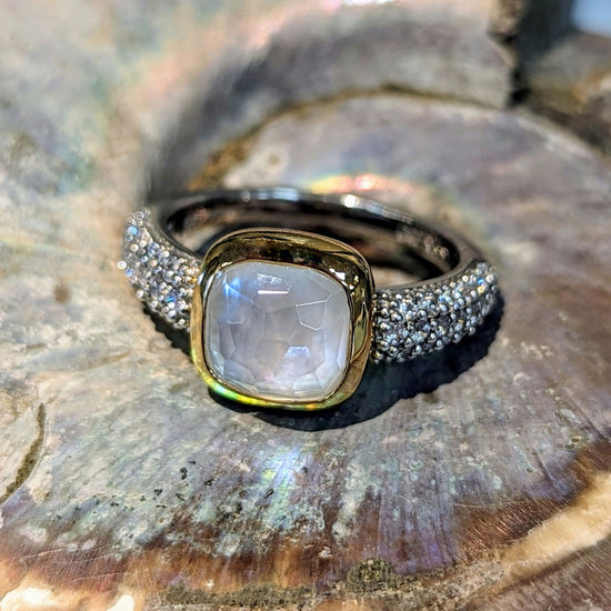 Photo of Cubic Zirconia Halo Bezel Ring in a decorative scene, designed by , available at Plumb Gold & Plumb Silver