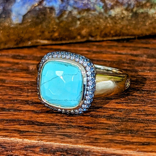 Photo of Cubic Zirconia Halo Bezel Ring in a decorative scene, designed by , available at Plumb Gold & Plumb Silver