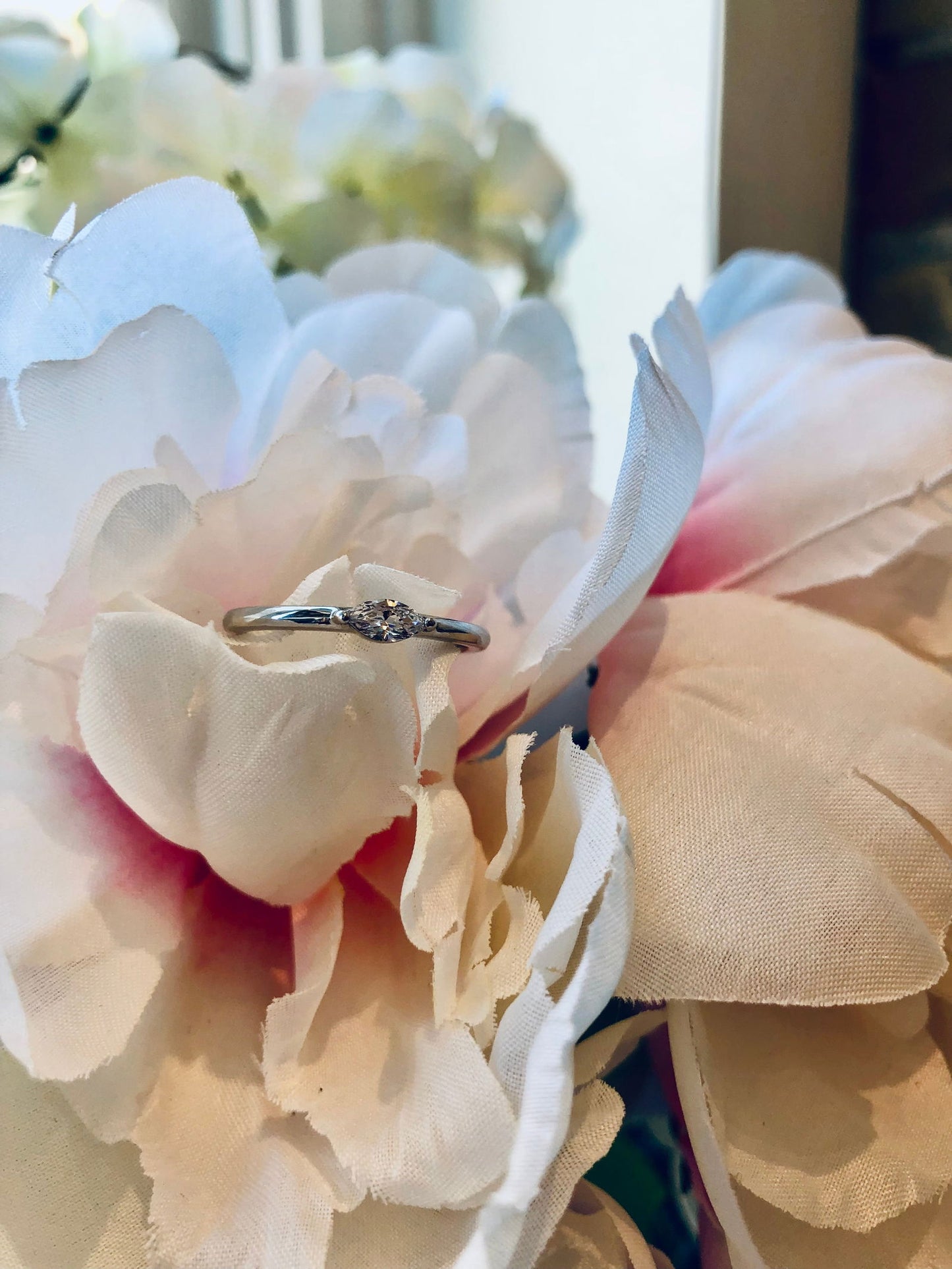 Photo of Cubic Zirconia Marquise ring in a decorative scene, designed by , available at Plumb Gold & Plumb Silver