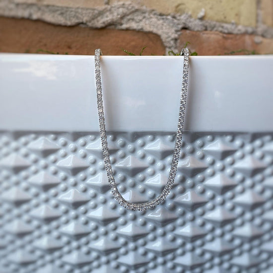 Photo of Cubic Zirconia Tennis Necklace in a decorative scene, designed by , available at Plumb Gold & Plumb Silver