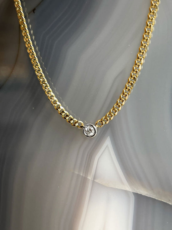 Photo of Curb Link Diamond Necklace in a decorative scene, designed by , available at Plumb Gold & Plumb Silver