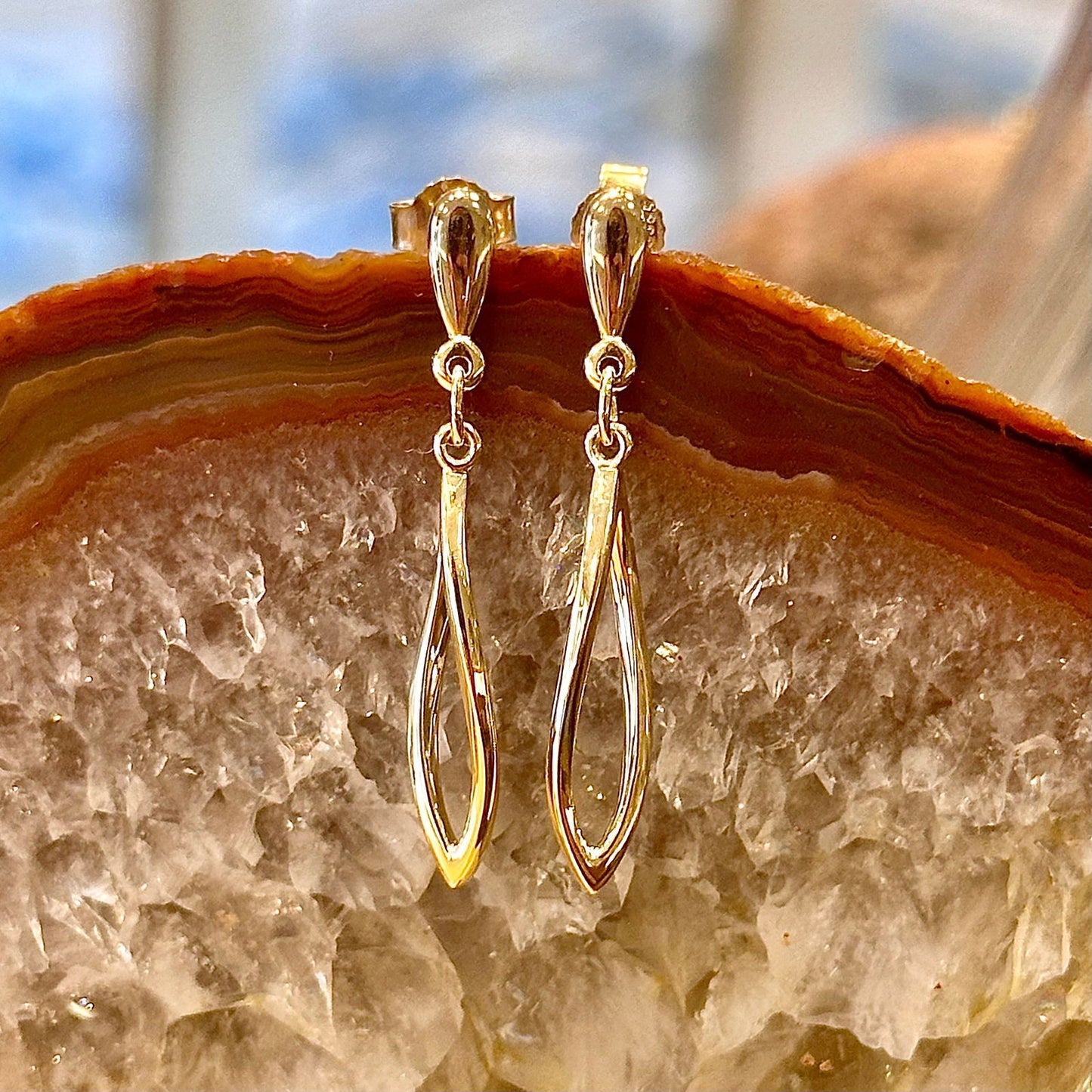 Photo of Curved Ellipse Dangle in a decorative scene, designed by -, available at Plumb Gold & Plumb Silver
