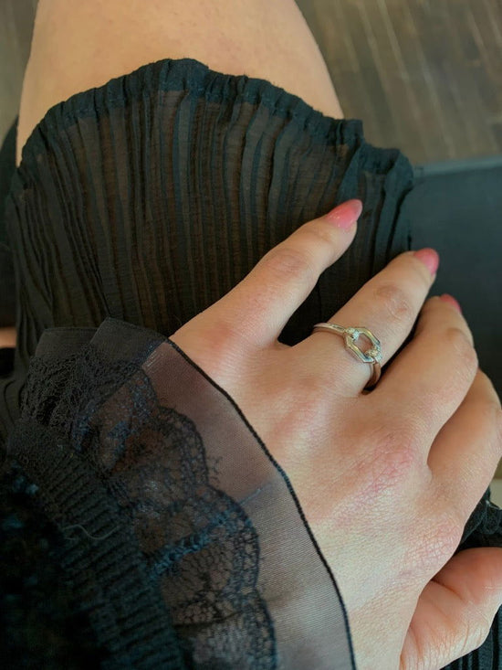 Photo of Cz Link ring in a decorative scene, designed by , available at Plumb Gold & Plumb Silver