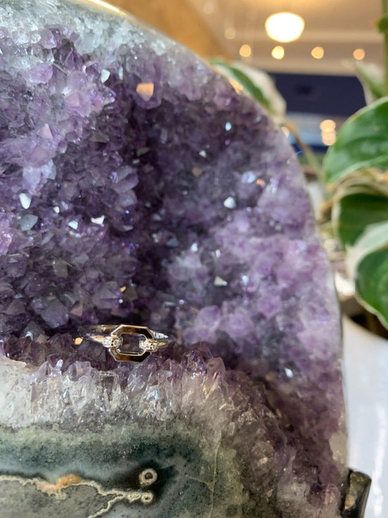 Photo of Cz Link ring in a decorative scene, designed by , available at Plumb Gold & Plumb Silver