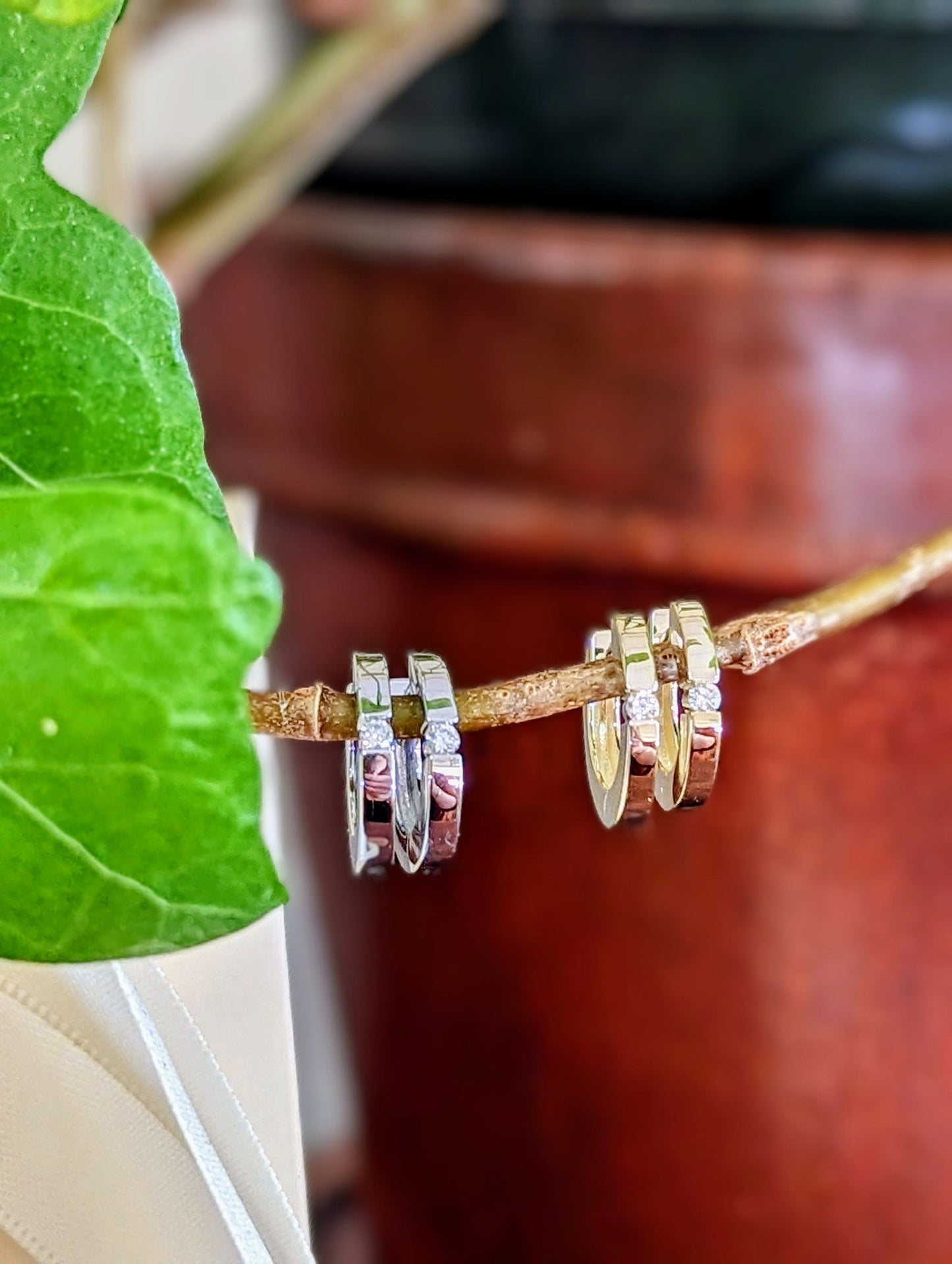 Photo of Diamond Channel Huggie in a decorative scene, designed by , available at Plumb Gold & Plumb Silver