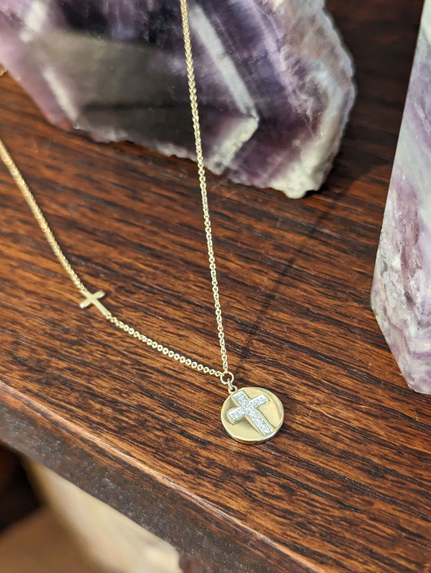 Photo of Diamond Cross Disc Necklace in a decorative scene, designed by , available at Plumb Gold & Plumb Silver