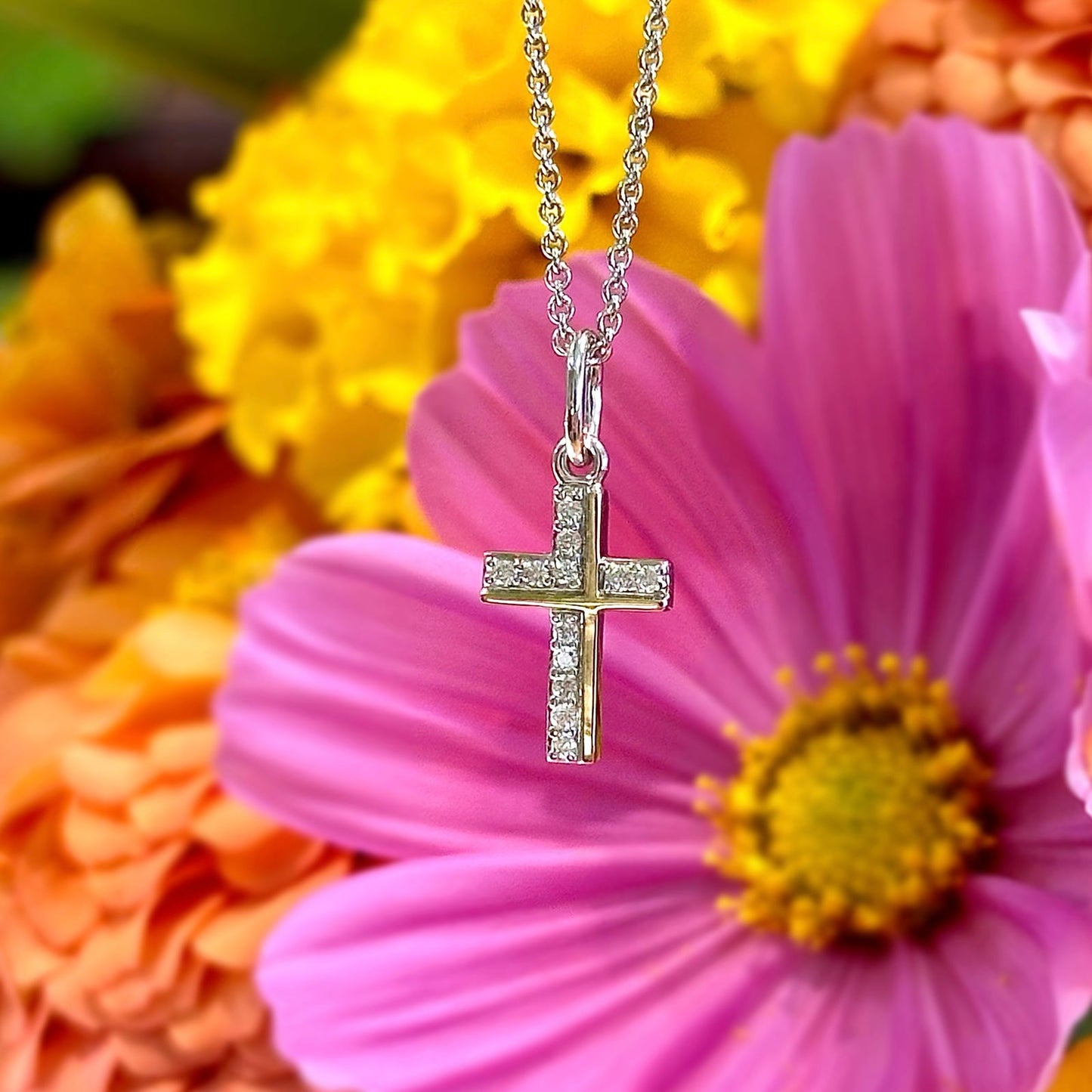 Photo of Diamond Cross Pendant in a decorative scene, designed by , available at Plumb Gold & Plumb Silver