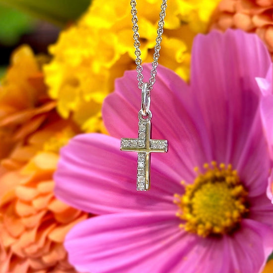 Photo of Diamond Cross Pendant in a decorative scene, designed by , available at Plumb Gold & Plumb Silver