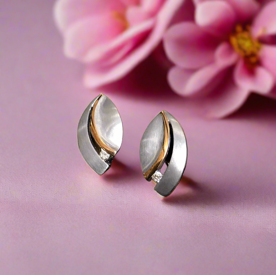 Photo of Diamond Leaf Earrings in a decorative scene, designed by , available at Plumb Gold & Plumb Silver