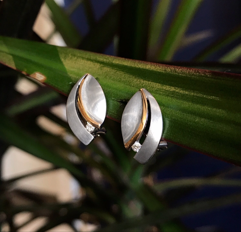 Photo of Diamond Leaf Earrings in a decorative scene, designed by , available at Plumb Gold & Plumb Silver