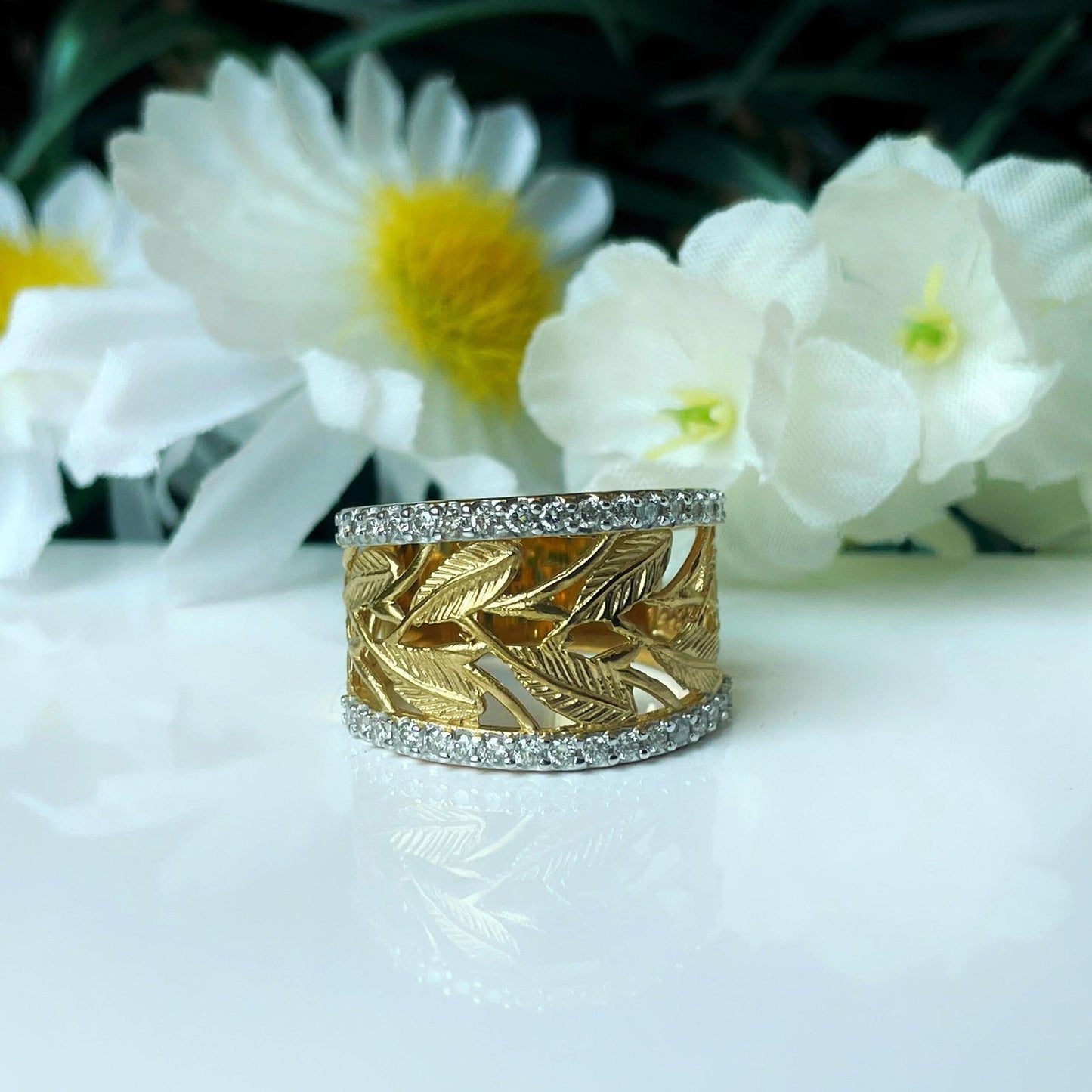 Photo of Diamond Leaves Ring in a decorative scene, designed by , available at Plumb Gold & Plumb Silver