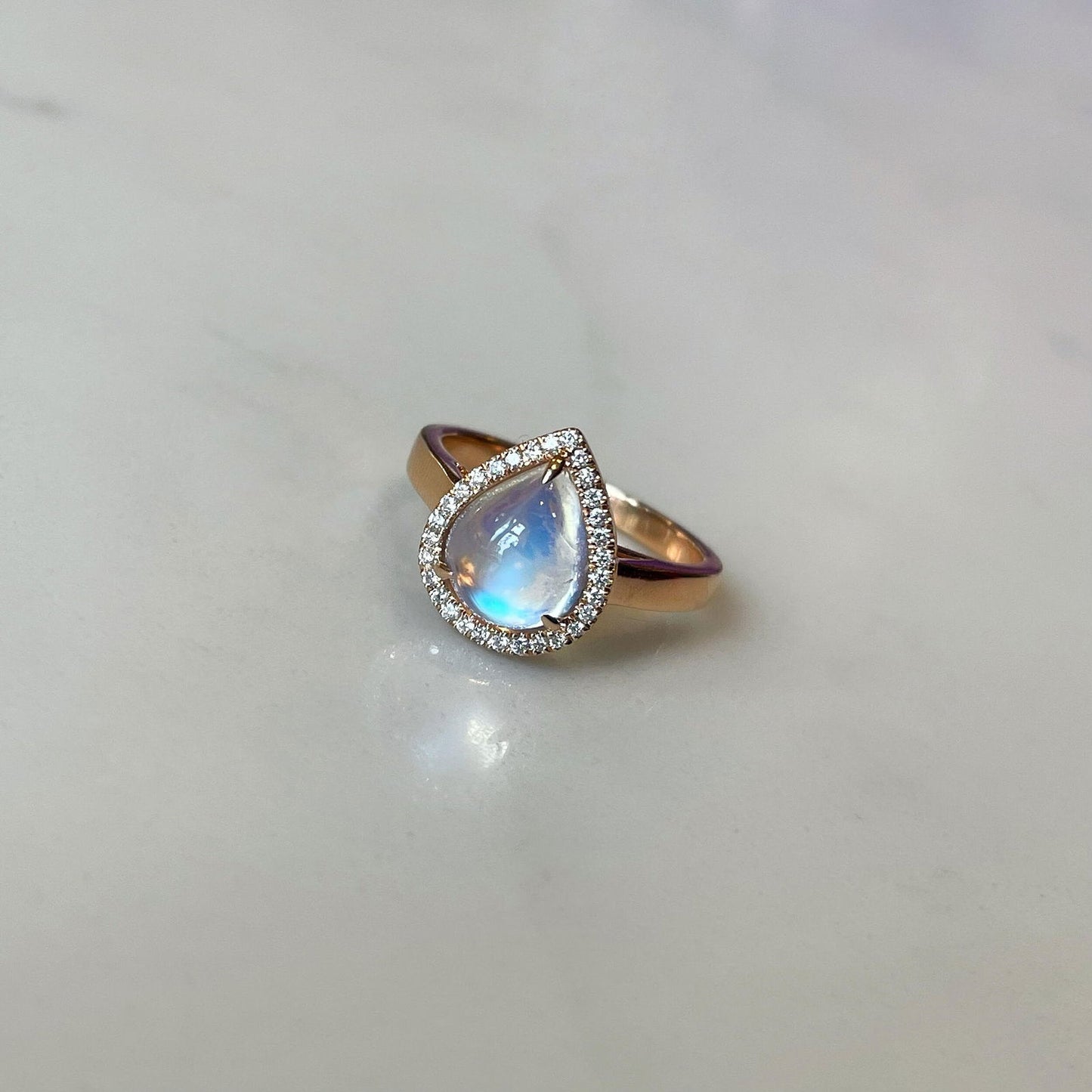 Photo of Diamond Moonstone Ring in a decorative scene, designed by , available at Plumb Gold & Plumb Silver