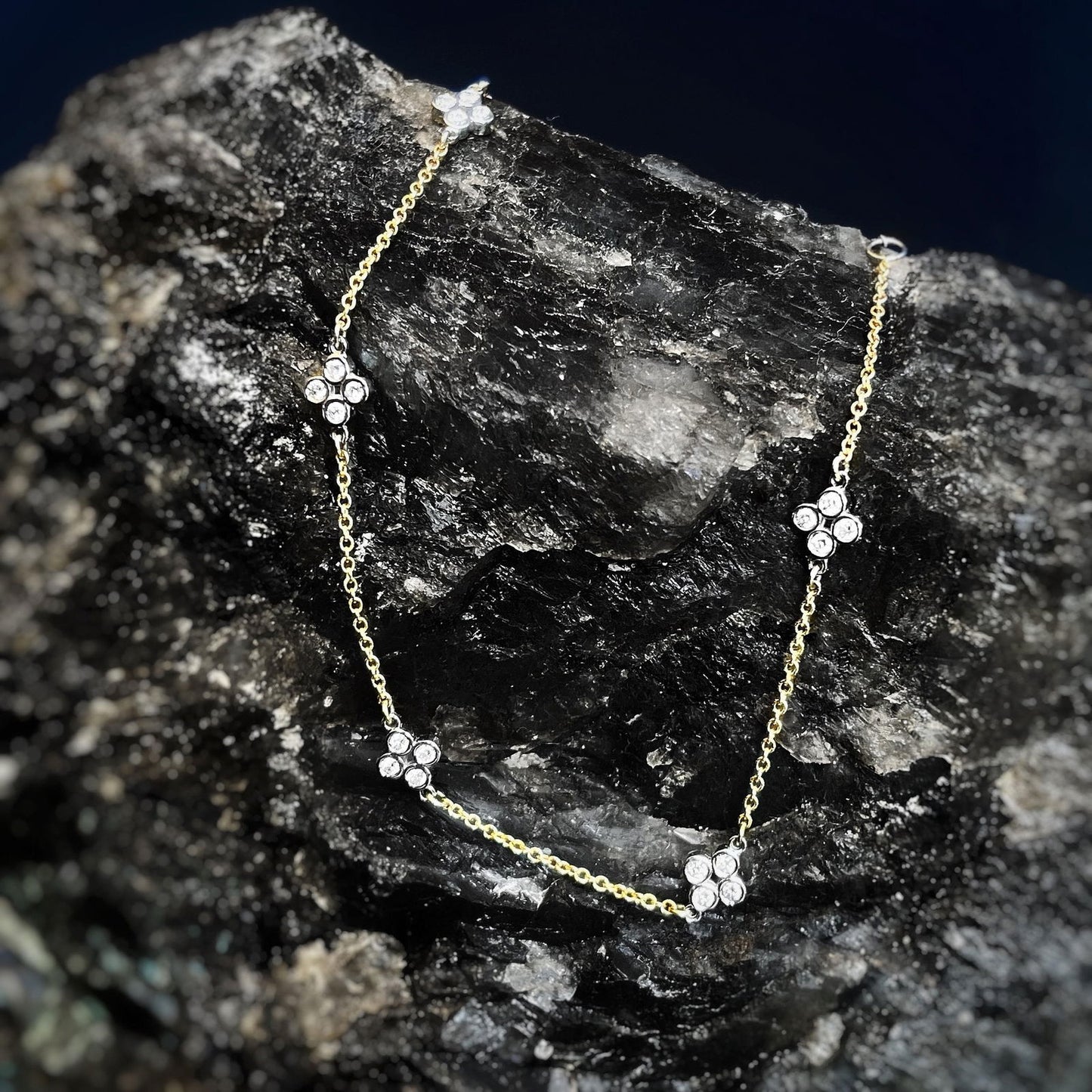 Photo of Diamond Quatrefoil Station Bracelet in a decorative scene, designed by , available at Plumb Gold & Plumb Silver