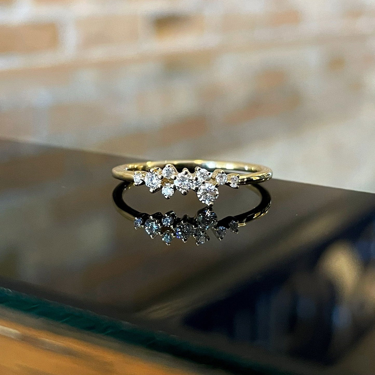 Photo of Diamond Scatter Ring in a decorative scene, designed by , available at Plumb Gold & Plumb Silver