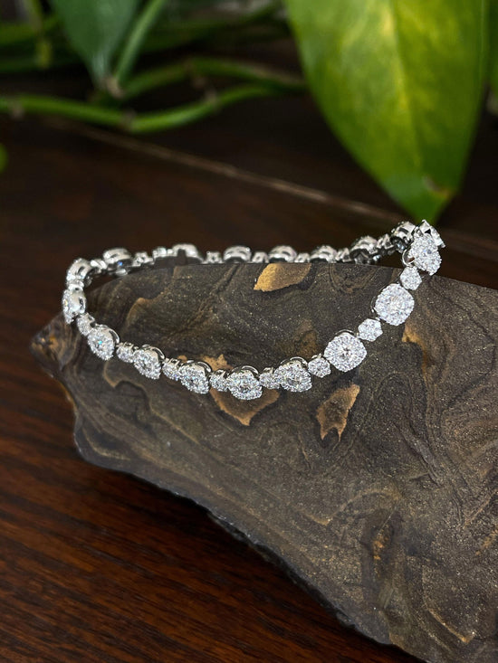 Photo of Diamond Tennis Bracelet in a decorative scene, designed by , available at Plumb Gold & Plumb Silver