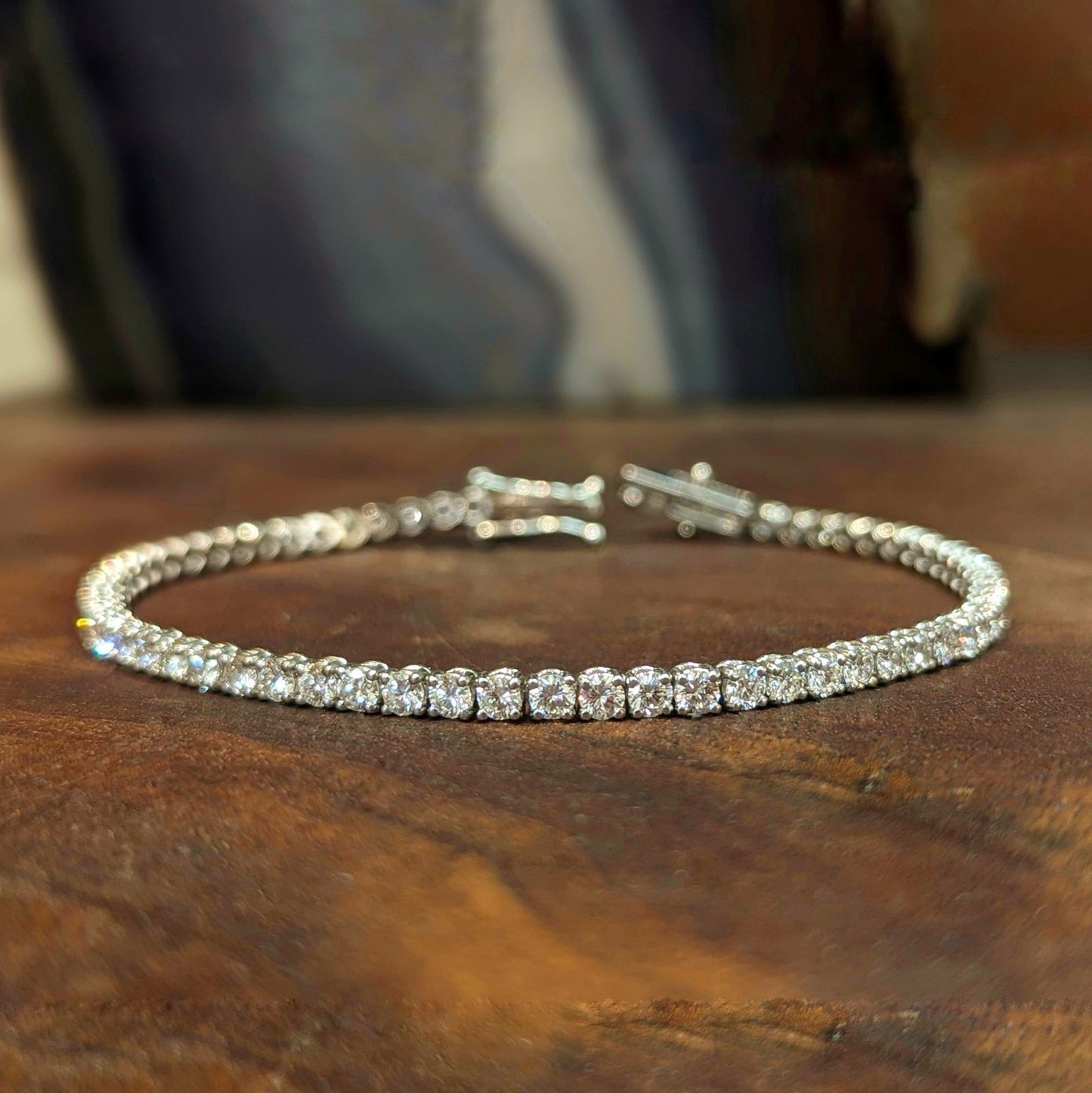 Photo of Diamond Tennis Bracelet in a decorative scene, designed by , available at Plumb Gold & Plumb Silver