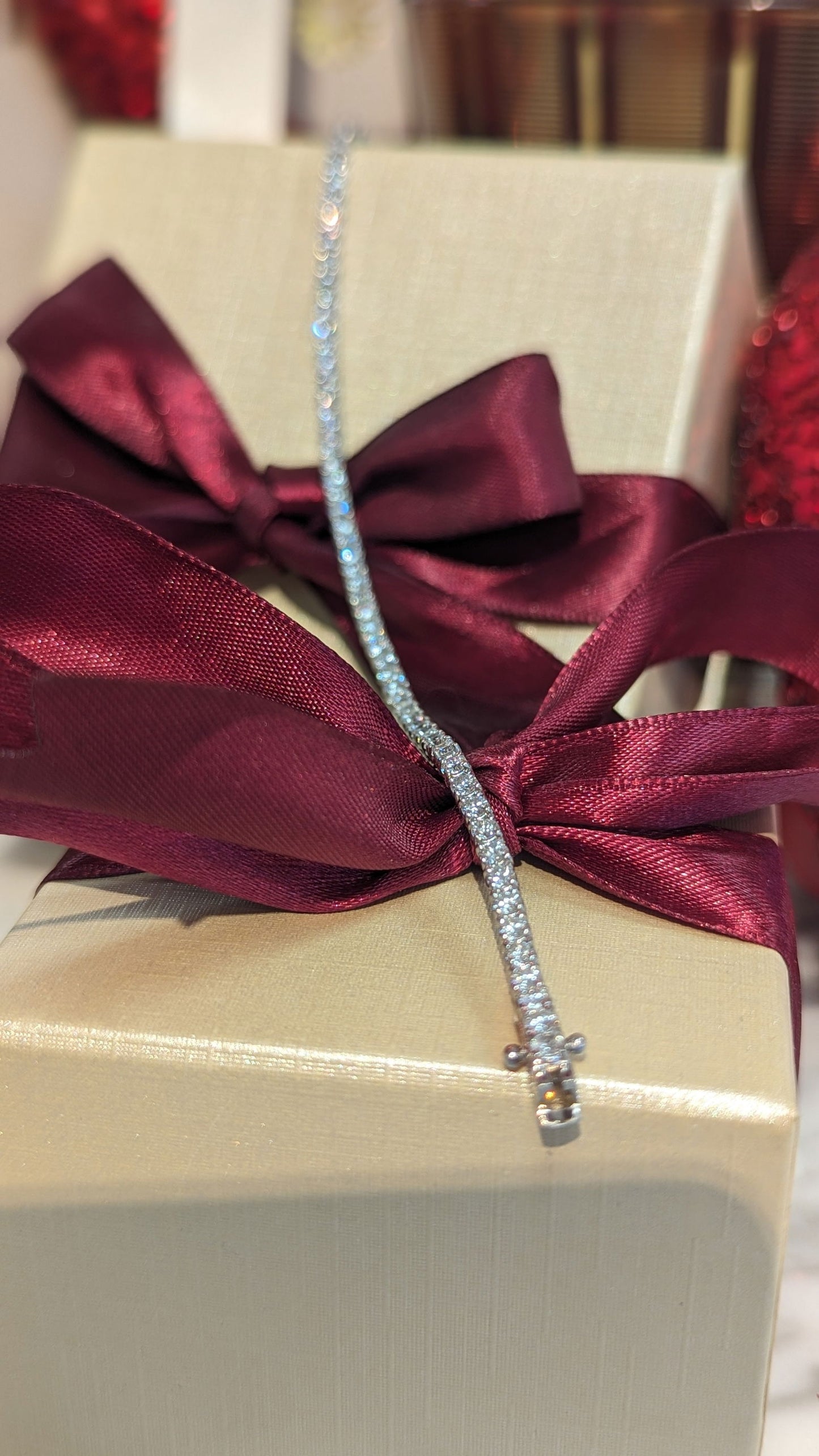 Photo of Diamond Tennis Bracelet in a decorative scene, designed by , available at Plumb Gold & Plumb Silver