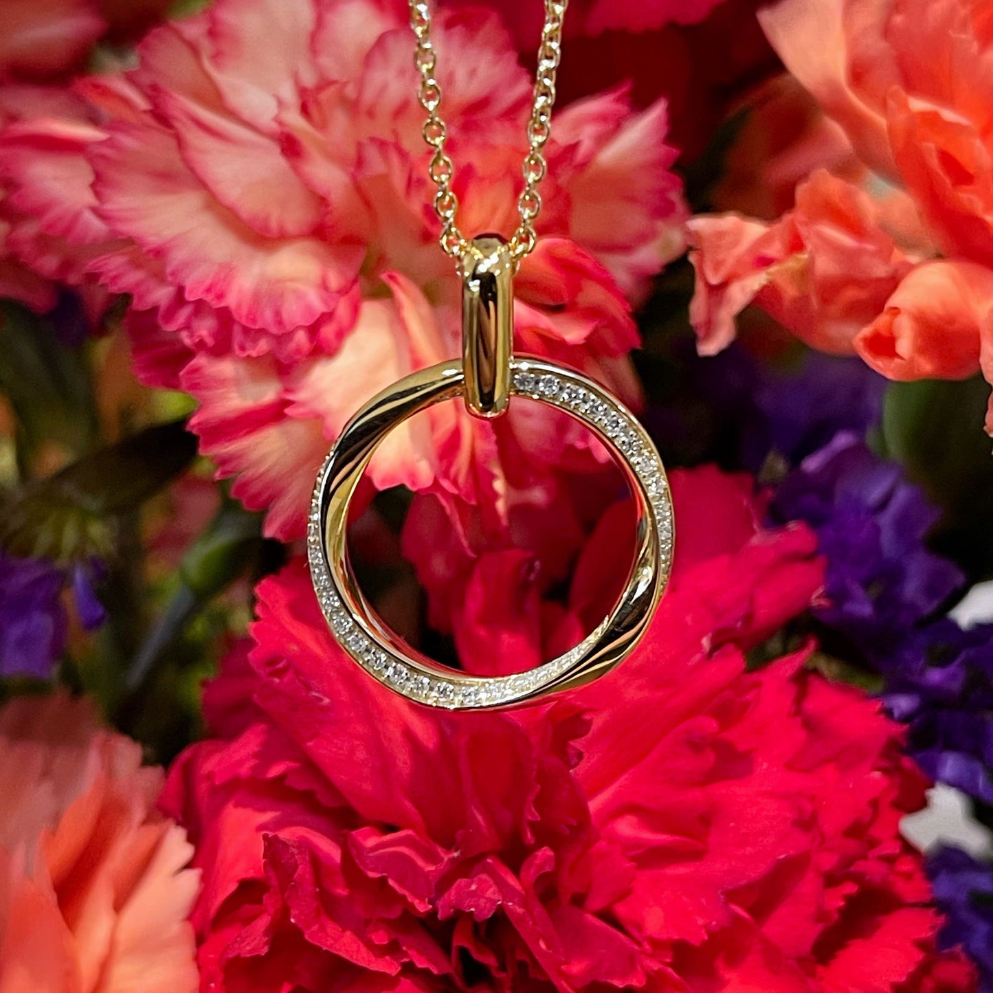 Photo of Diamond Twist Pendant in a decorative scene, designed by , available at Plumb Gold & Plumb Silver