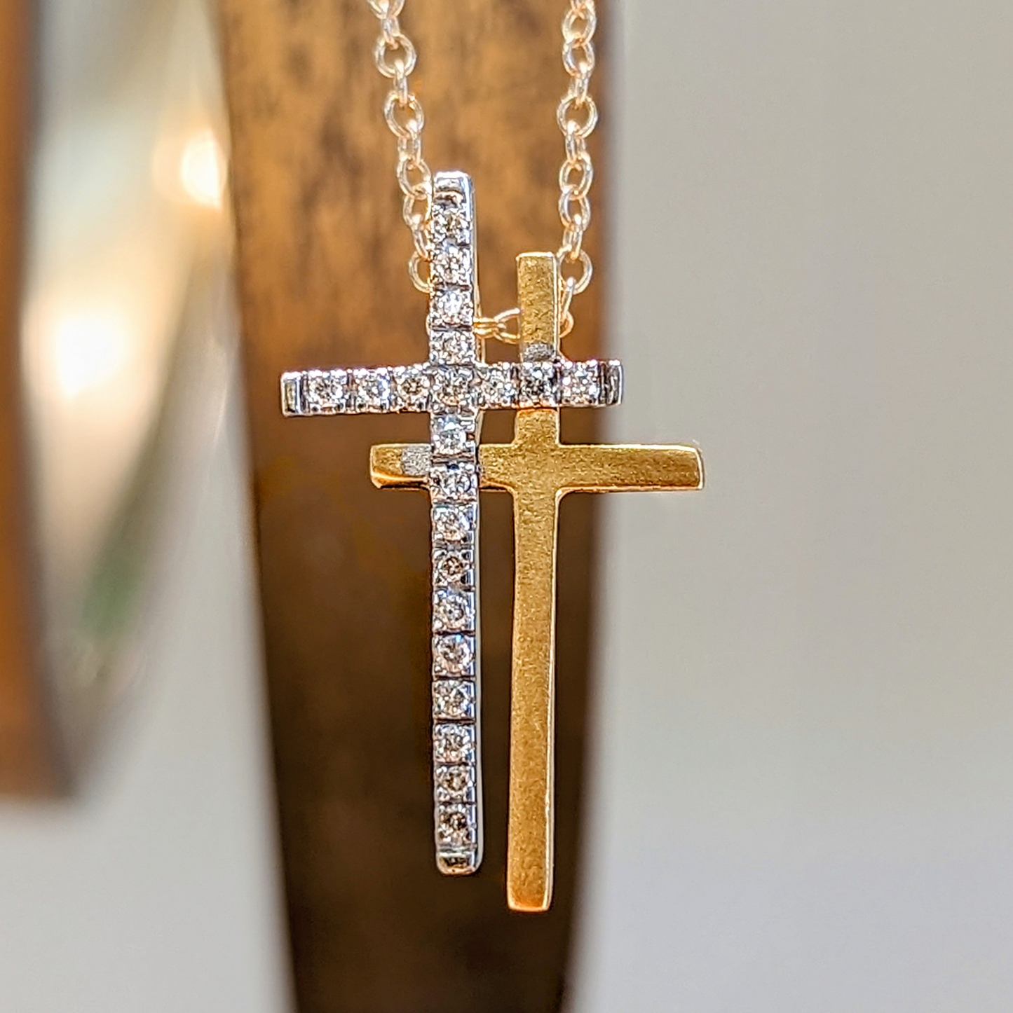 Photo of Double Cross Necklace in a decorative scene, designed by , available at Plumb Gold & Plumb Silver