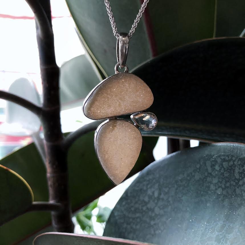 Photo of Drusy and Green Quartz Pendant in a decorative scene, designed by , available at Plumb Gold & Plumb Silver