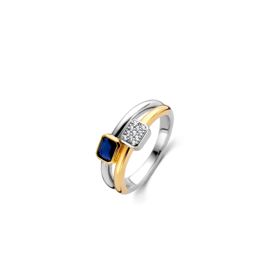 Photo of "Duo" Blue Bezel CZ Cluster Ring in a decorative scene, designed by , available at Plumb Gold & Plumb Silver