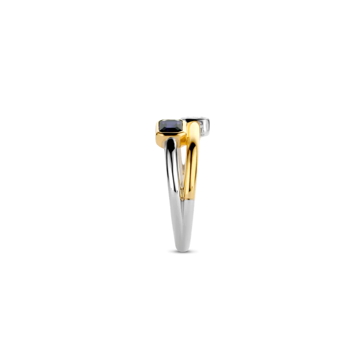 Photo of "Duo" Blue Bezel CZ Cluster Ring in a decorative scene, designed by , available at Plumb Gold & Plumb Silver
