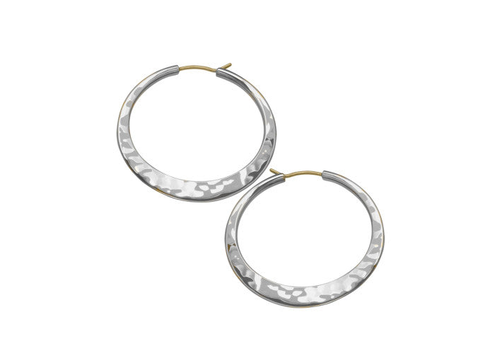 Photo of EL Design Large "Hammered" Flat Hoop Earrings in a decorative scene, designed by , available at Plumb Gold & Plumb Silver