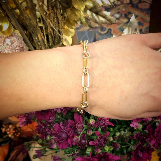 Photo of Elongated Link Two Tone Bracelet in a decorative scene, designed by -, available at Plumb Gold & Plumb Silver