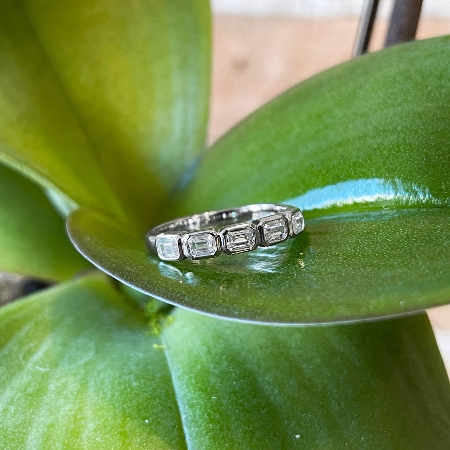 Photo of Emerald-Cut Cubic Zirconia Ring in a decorative scene, designed by , available at Plumb Gold & Plumb Silver