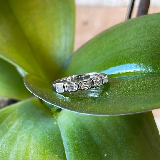 Photo of Emerald-Cut Cubic Zirconia Ring in a decorative scene, designed by , available at Plumb Gold & Plumb Silver