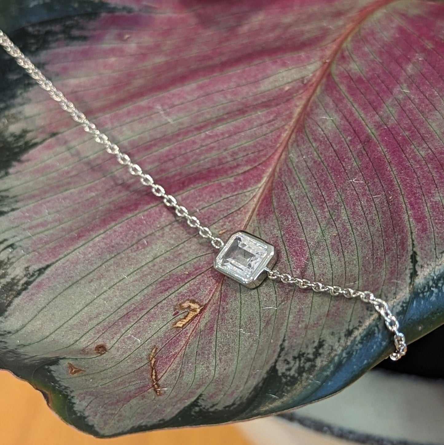 Photo of Emerald Cut Cubic Zirconia Bracelet in a decorative scene, designed by , available at Plumb Gold & Plumb Silver