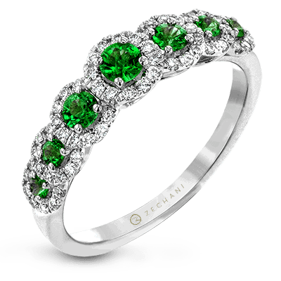 Photo of Emerald Seven Halo Ring in a decorative scene, designed by , available at Plumb Gold & Plumb Silver