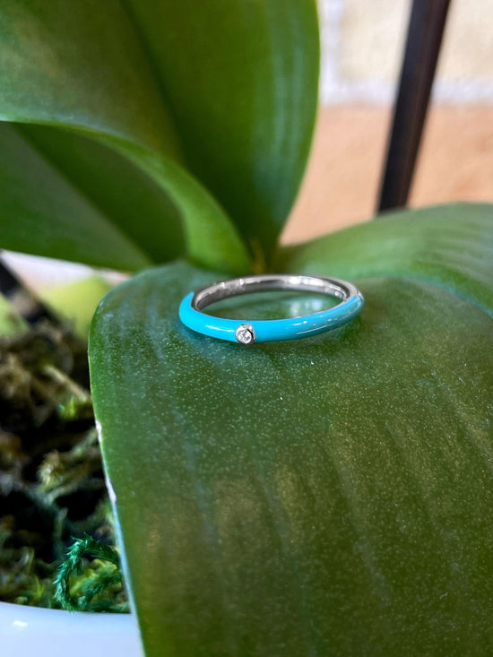 Photo of Enamel Bezel Band in a decorative scene, designed by , available at Plumb Gold & Plumb Silver