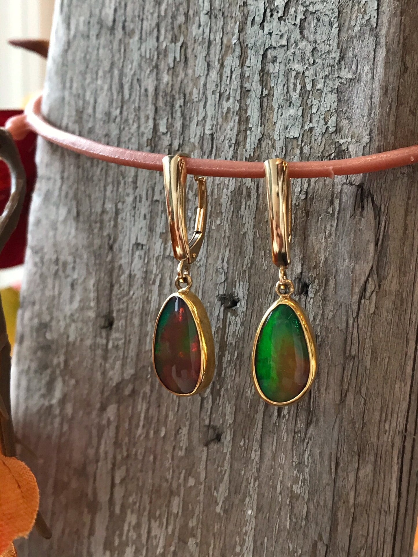 Photo of Ethiopian Opal Oval Dangles in a decorative scene, designed by , available at Plumb Gold & Plumb Silver