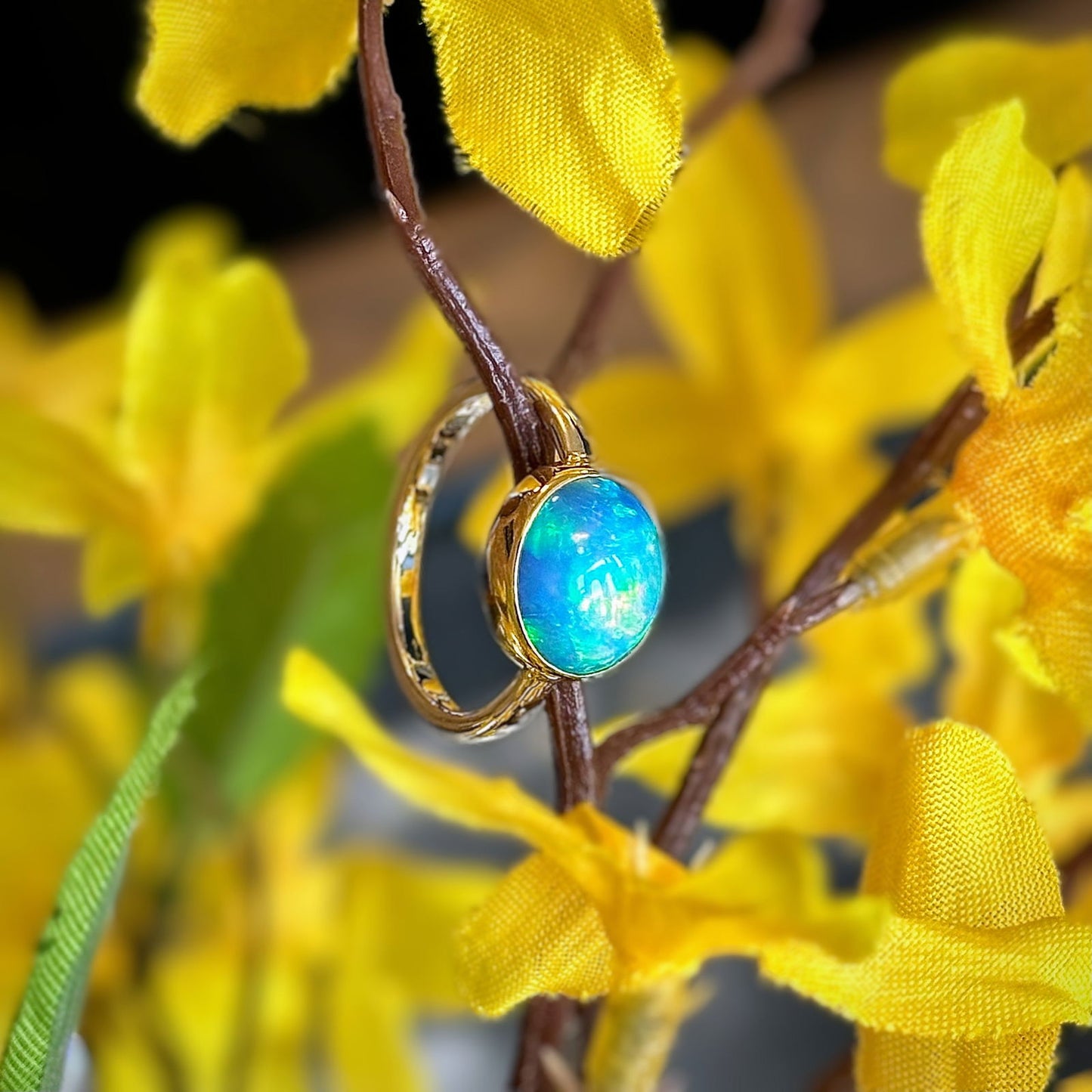 Photo of Ethiopian Opal Oval Ring in a decorative scene, designed by , available at Plumb Gold & Plumb Silver