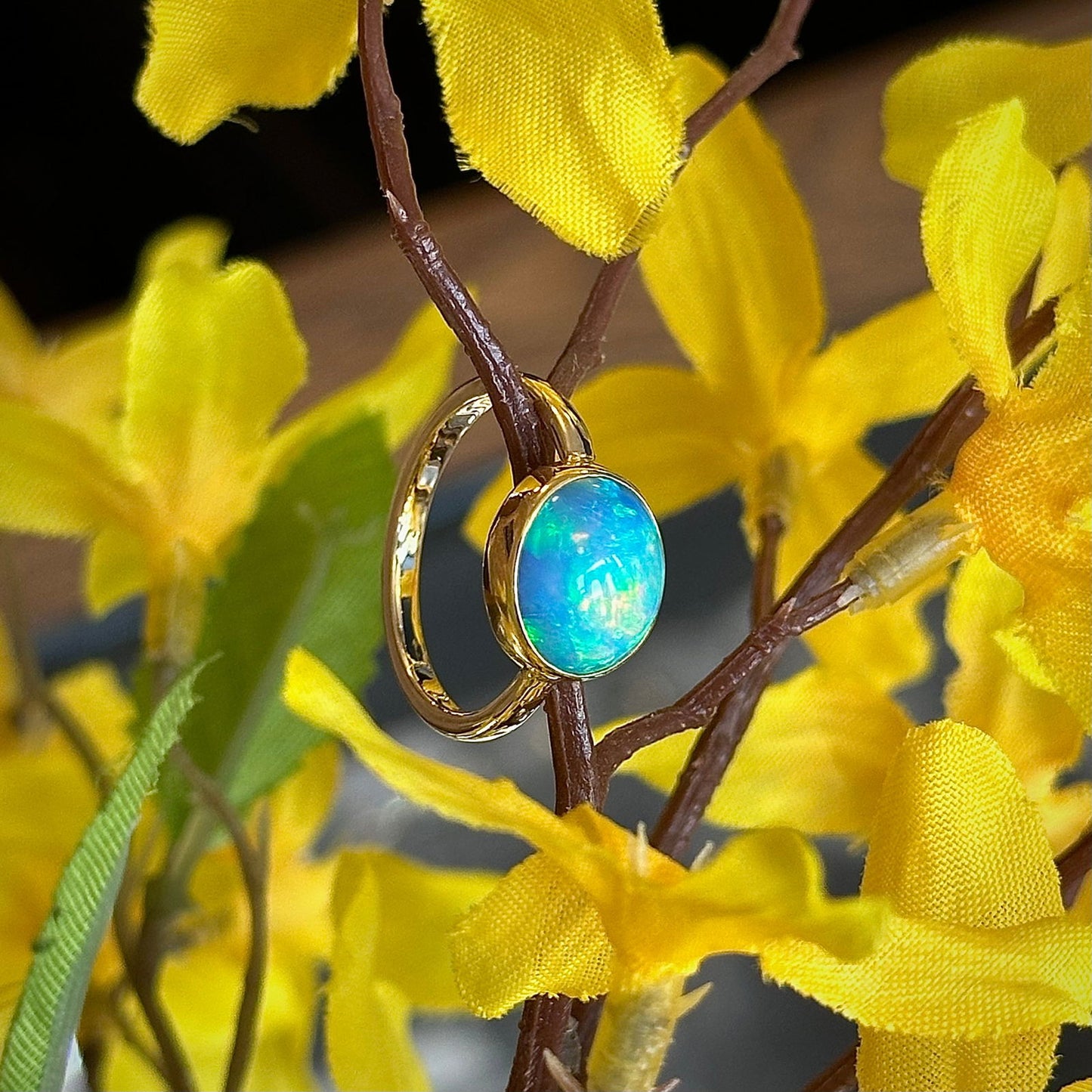 Photo of Ethiopian Opal Oval Ring in a decorative scene, designed by , available at Plumb Gold & Plumb Silver